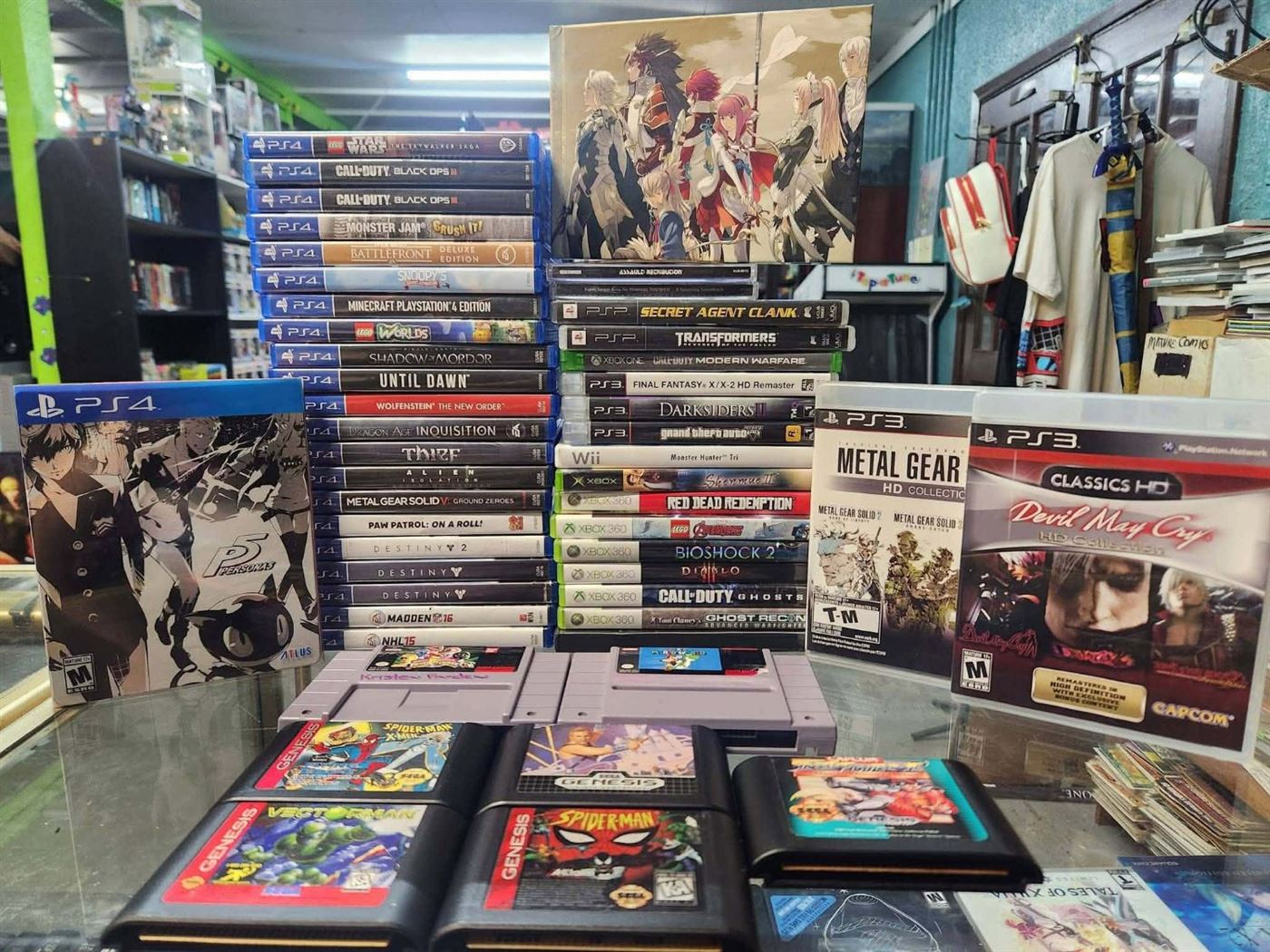 Persona 5 steelbook, PS4 and Xbox games, SNES and Genesis cartridges