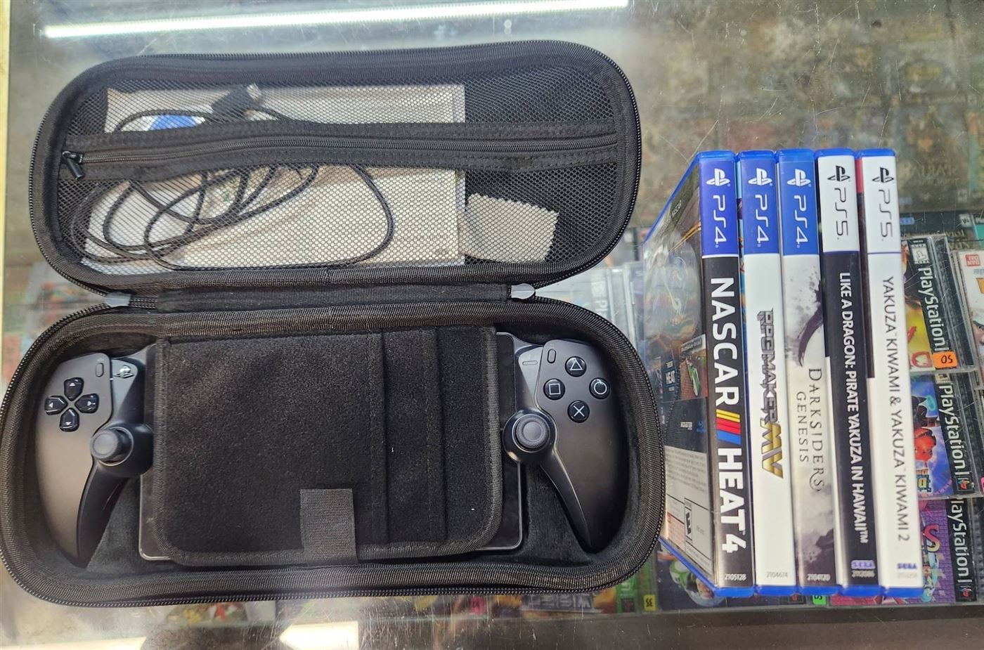 PlayStation Portal in its case with PS4 and PS5 games